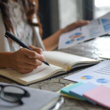 Financial Planning and Trust executive women are checking data from graphs and taking notes
